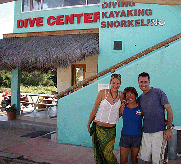 Jon and Stacy pose in front of the dive center with their instructor for the next week Pilu Hermosilla